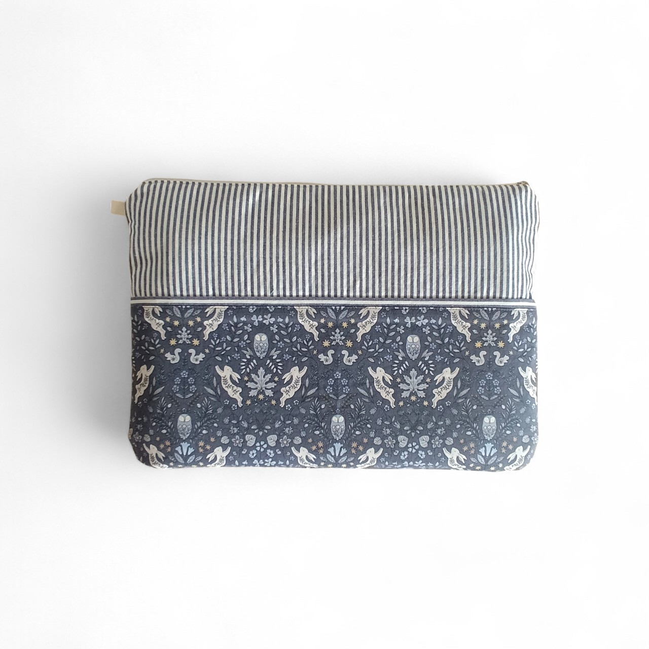 a-back-view-of-a-navy-and-cream-laptop-sleeve