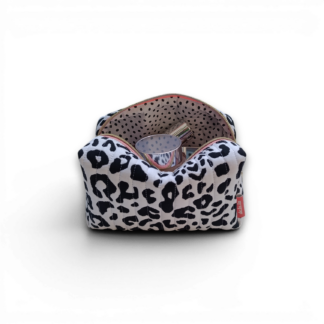 side-on-styled-view-of-a-black-and-white-quilted-boxy-bag-with-a-salmon-coloured-zipper-and-brand-lable